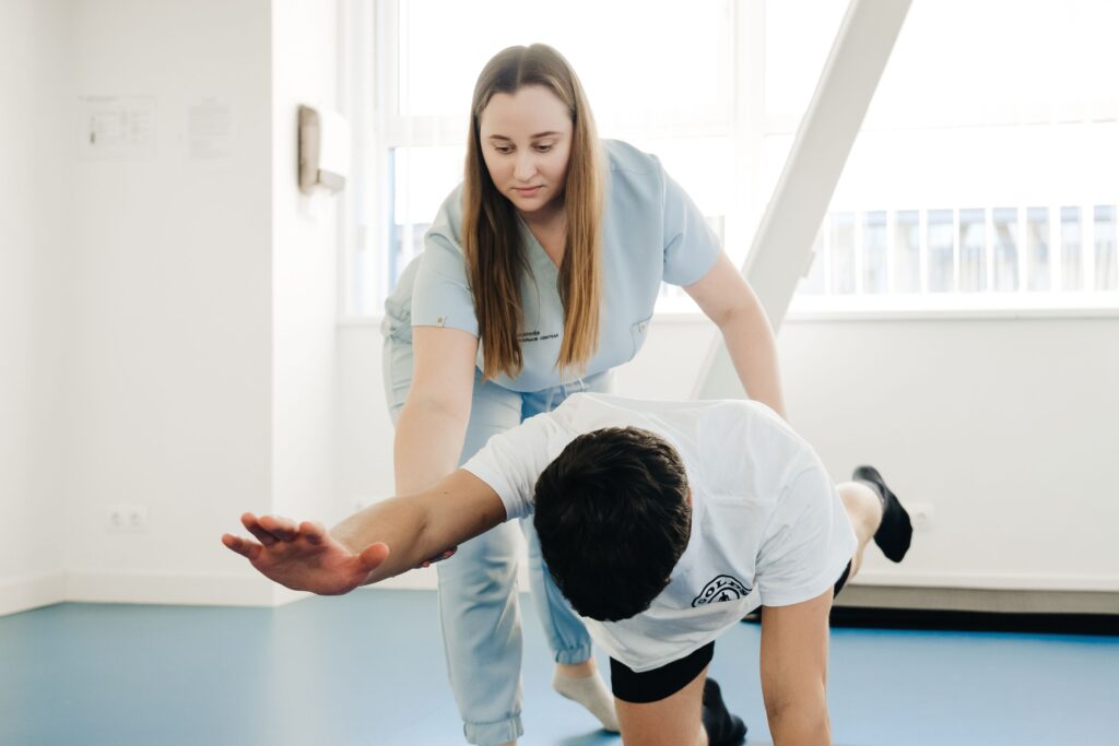 Physiotherapist guiding a patient through a home exercise session in Southern River